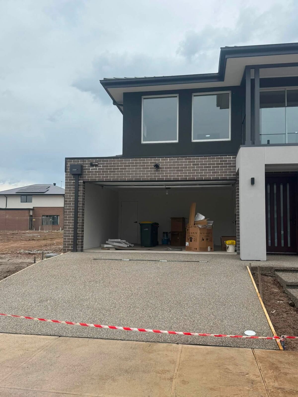 Exposed aggregate driveway leading to a garage