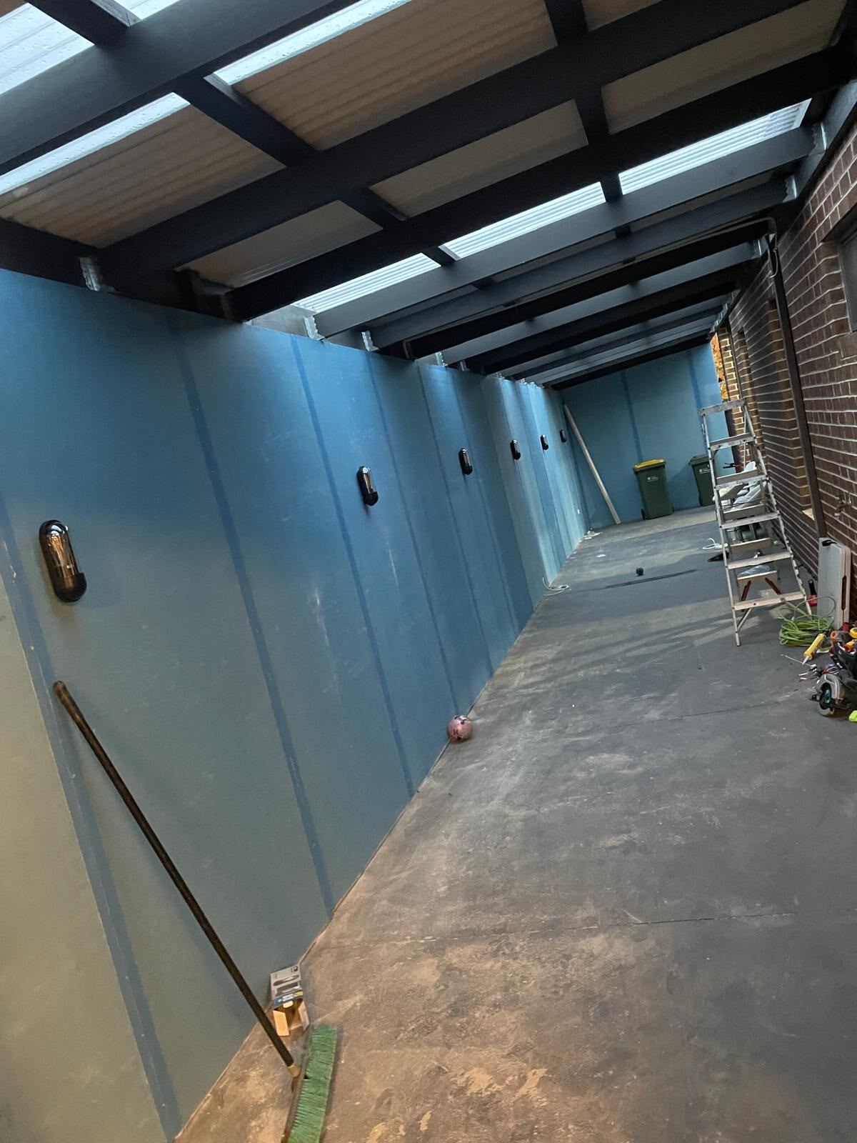 Feature wall cladding being installed along an alfresco corridor