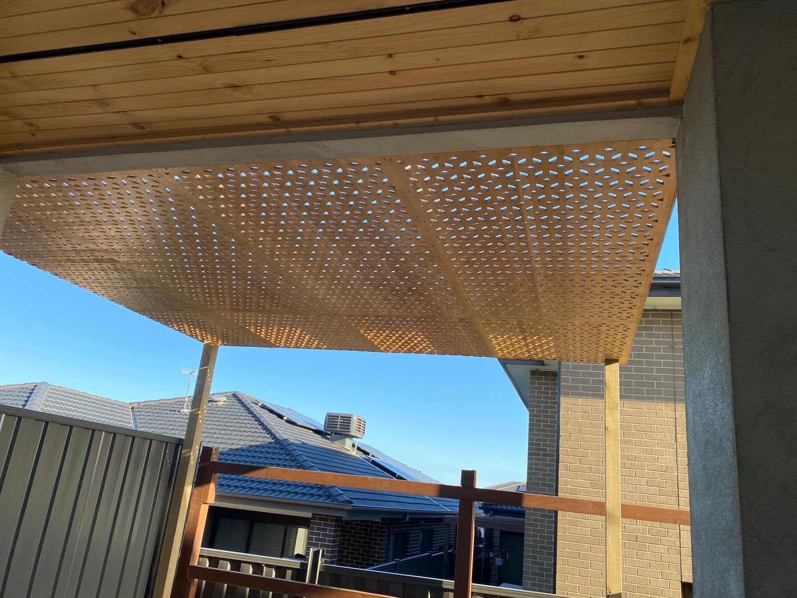 Pergola with a decorative perforated timber roof panel